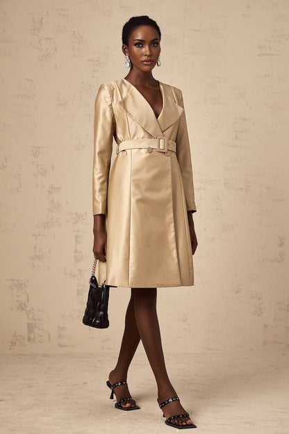 Woman wearing a long khaki trench coat with a belted waist