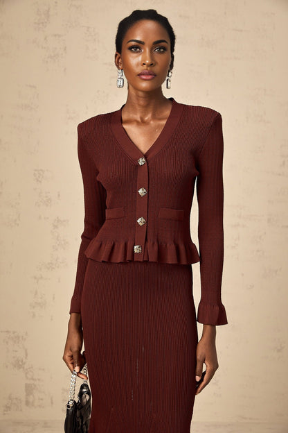 Woman wearing a red knit top with ruffles and matching skirt set called Corrine