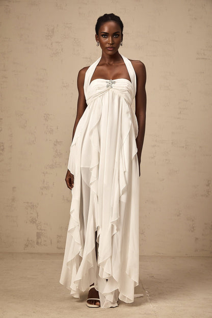 A long white chiffon maxi dress with ruffle details and a halter neckline