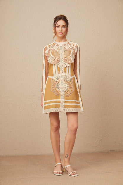 A short lace mini dress with cutout details and a peplum waist in a light color likely white or ivory