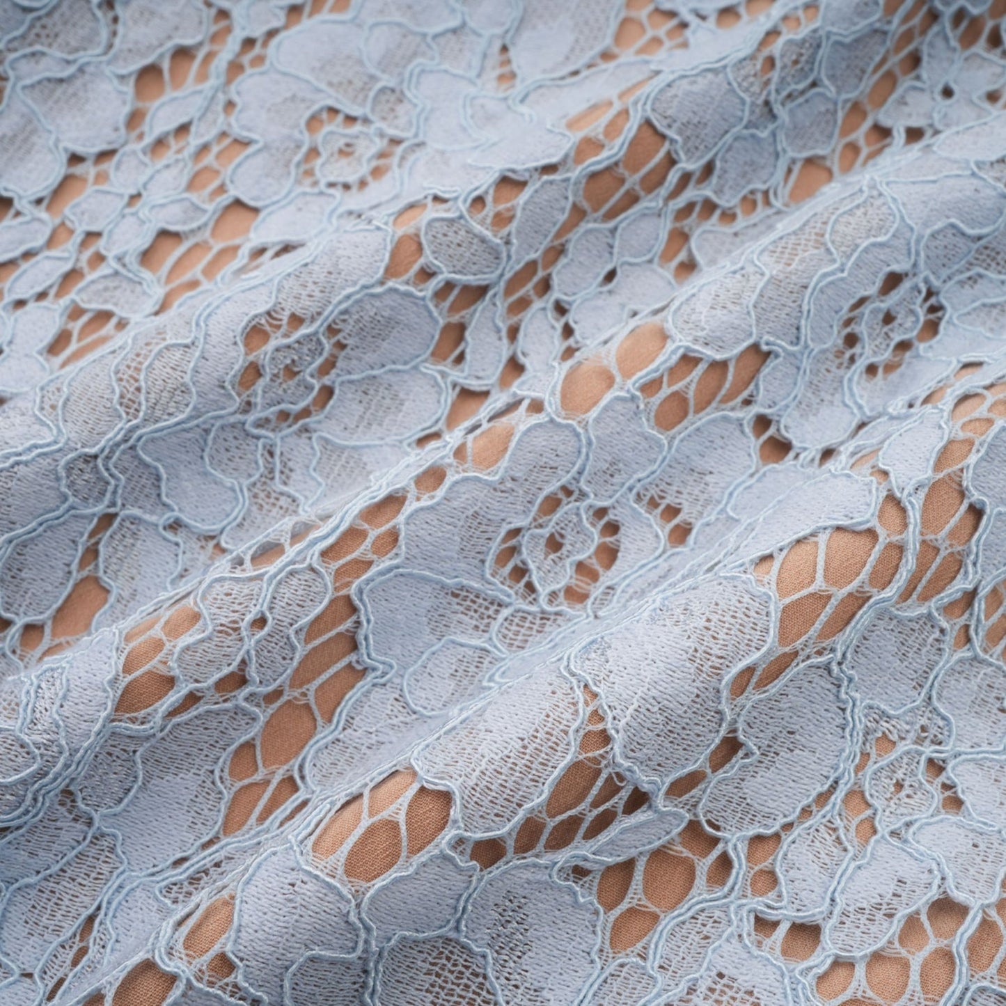 Woman wearing blue midi dress with floral lace pattern and boned bodice