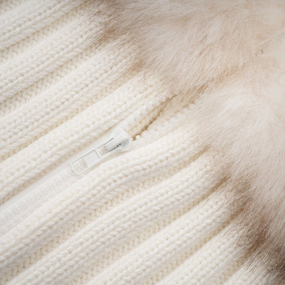 Woman wearing a beige faux fur jacket with ribbed knit texture and cozy collar