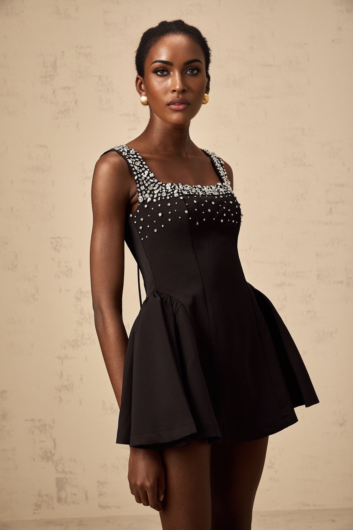 Black mini dress with flared skirt and crystal embellishments