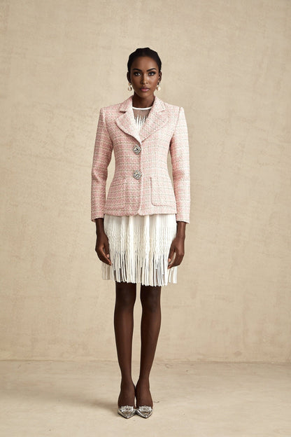 Woman wearing a pink blazer with crystal embellishments and check pattern in tweed fabric