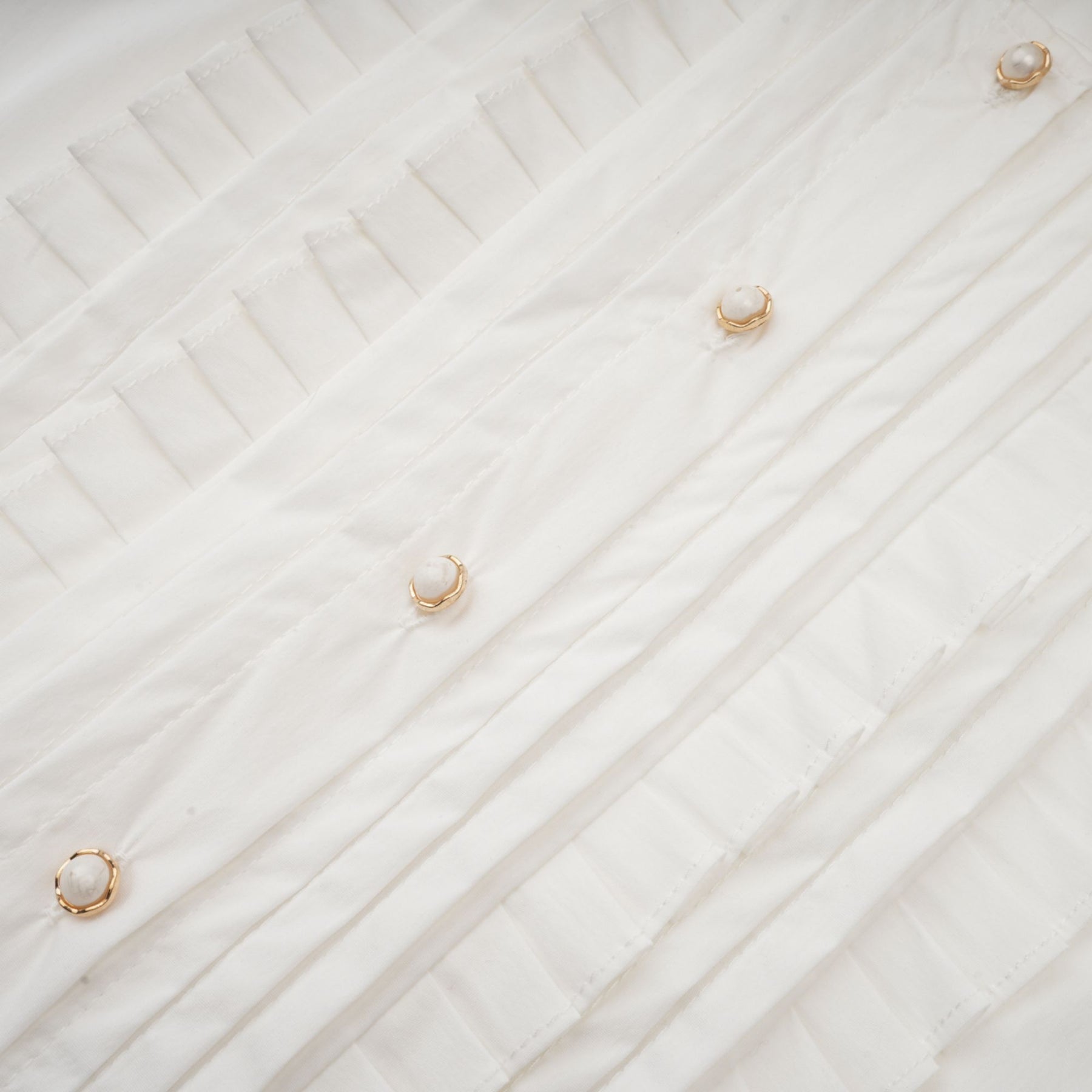 Céleste white pleated scarfcollar shirt