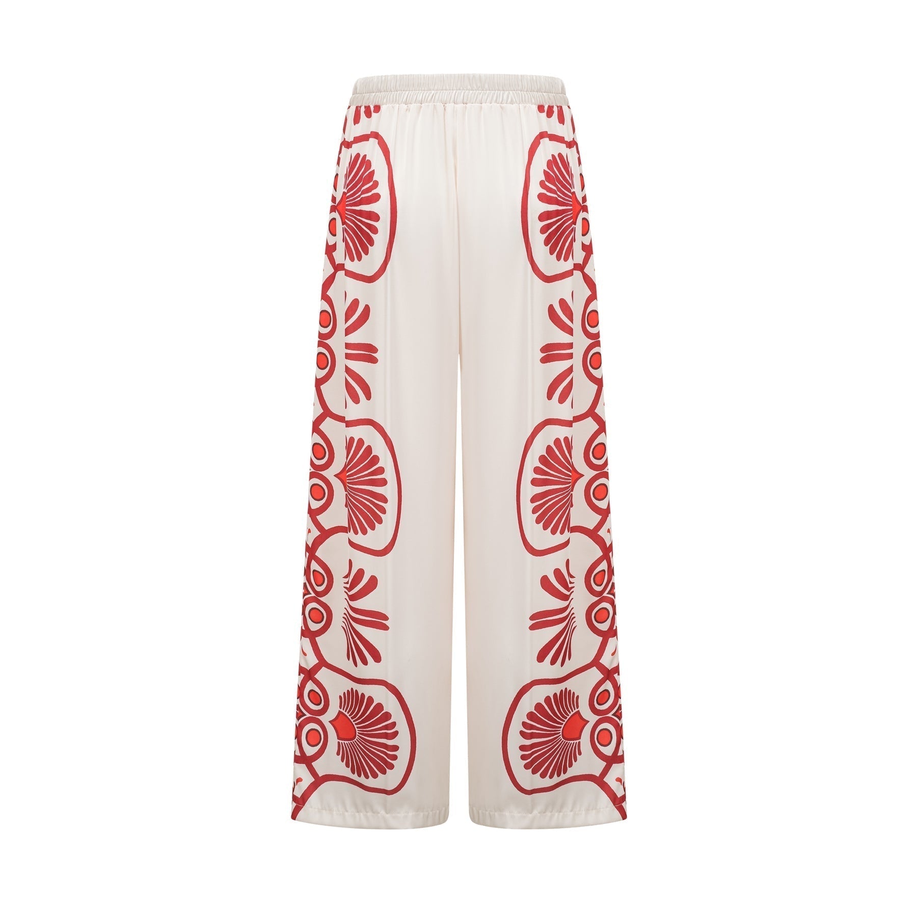 Woman wearing matching floral print shirt and trousers set in vibrant colors with Amaranta design