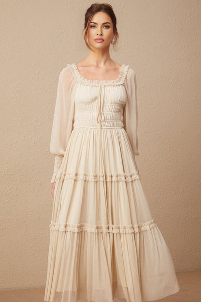 Woman wearing a pleated metallic midi dress with shirred detailing named Camille