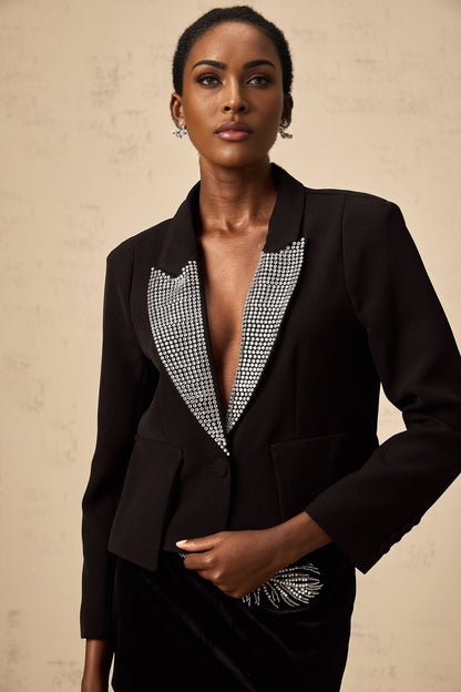 Woman wearing black blazer with crystal embellishments and V neckline