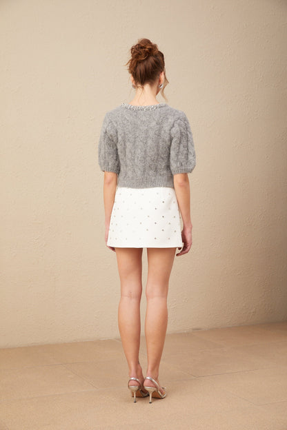 A cropped cable knit sweater in mohair featuring embellishments and a textured pattern named Ophelie