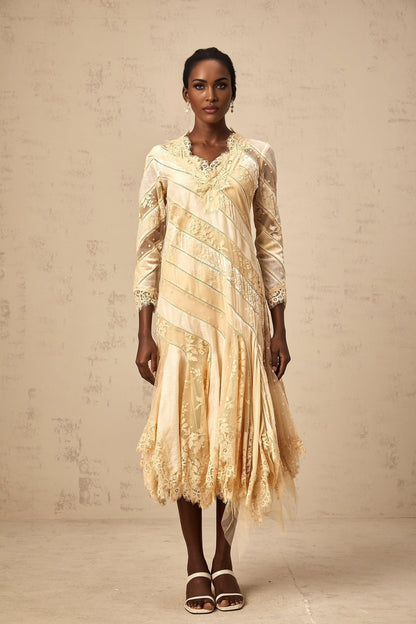 A beige midi dress with diagonal stripes and panel details named Ingrid
