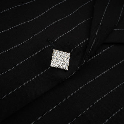 Woman wearing a black blazer with white stripes and open back design