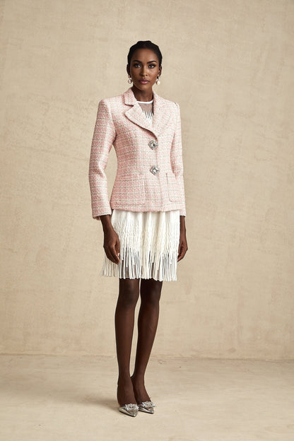 A pink blazer with crystal embellishments and a checked tweed pattern