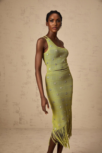 Woman wearing a green knitted matching set consisting of an embellished top and skirt named Annette