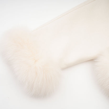 Woman wearing short white suede coat with fur trim and padded design