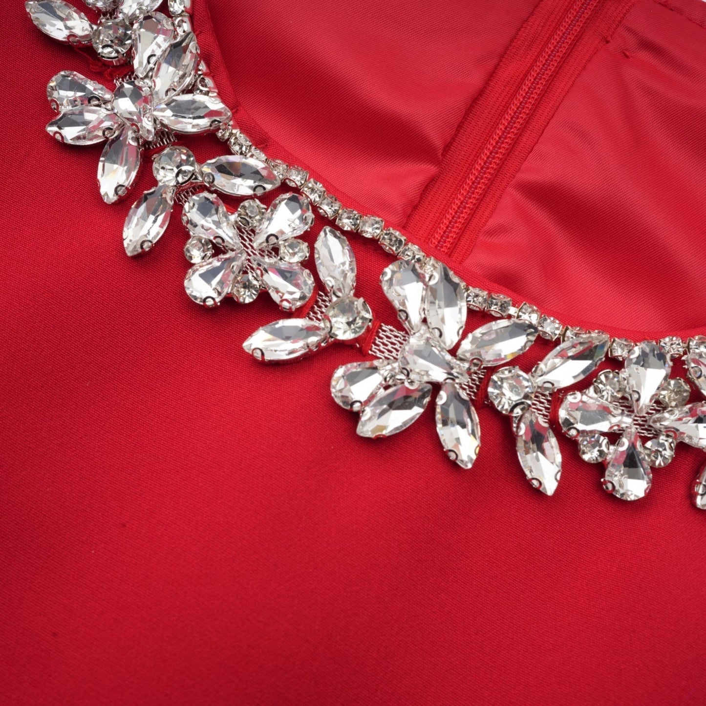 A red mini dress with pleated fabric and embellishments named Leonie