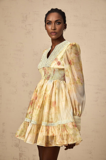 A short yellow mini dress with lace panels and a floral print pattern named Olivia