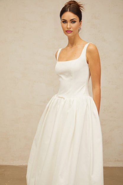 A white midi dress with a bowknot detail and flounced design named Perrine