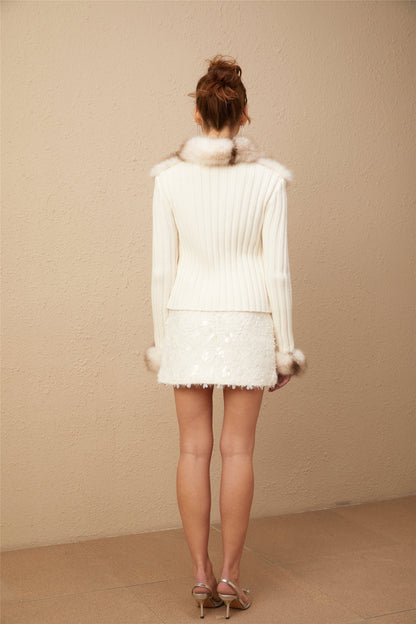 A cozy faux fur jacket with ribbed knit detailing named Laetiecia shown on a plain background