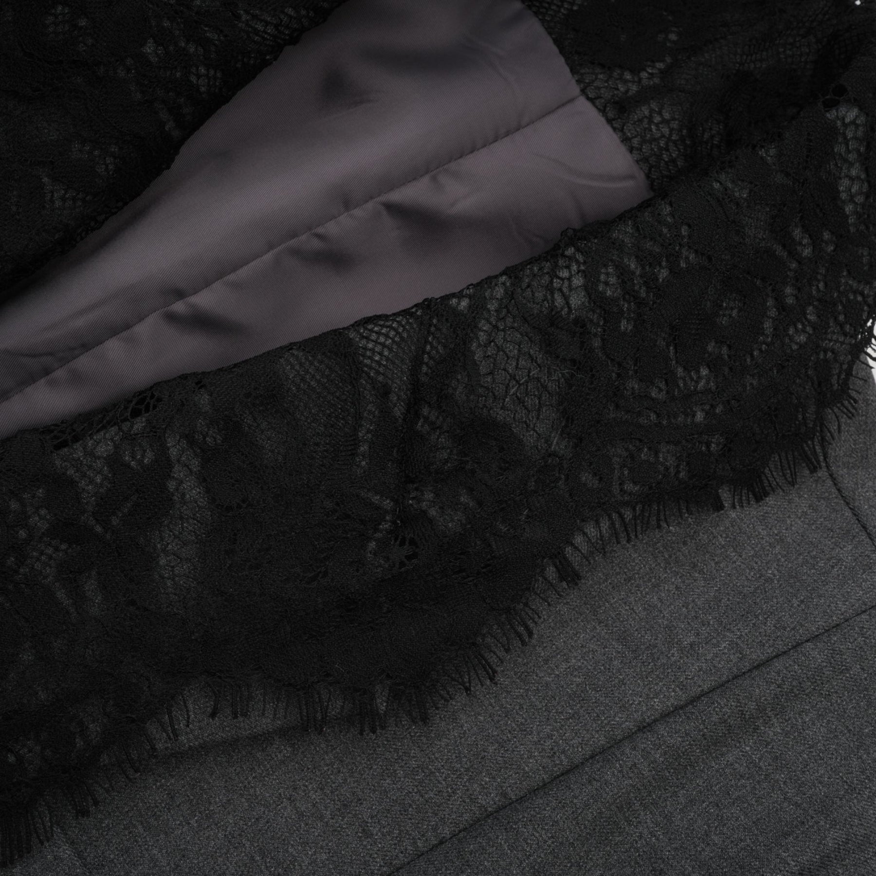 A grey blazer with lace panel detailing featuring a tailored silhouette and elegant design