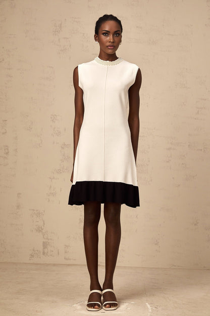 A white knitted cardigan adorned with faux pearl embellishments named Coralie