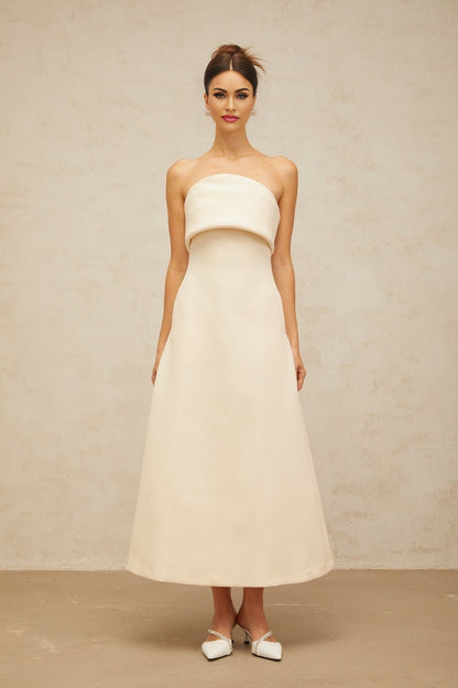 A white midi dress with a folded corset bodice and a fitted silhouette named Raphaelle