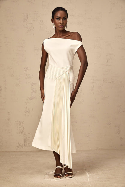 A white asymmetric midi dress with draped detailing featuring a unique silhouette and flowing fabric