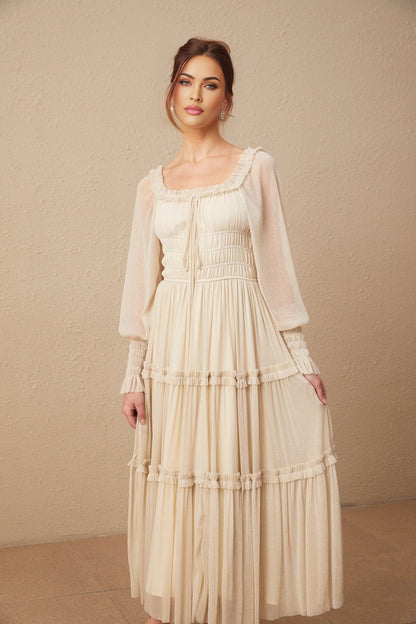 Woman wearing a pleated metallic midi dress with shirred detailing named Camille