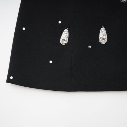 Black dress with bow and embellishment featuring Ysabeau design