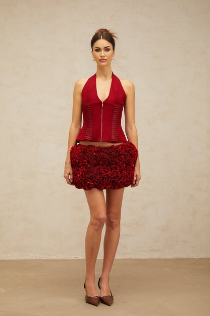 A red halterneck top with laceup detail in the front