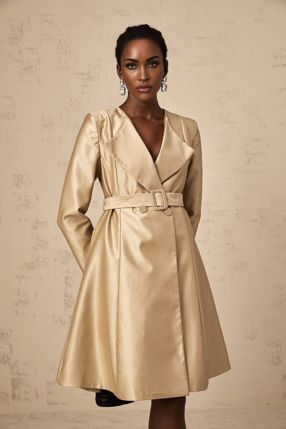 Woman wearing long khaki coat with belt cinched at waist