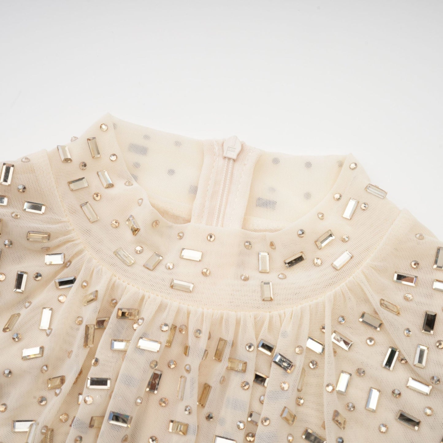 A short draped mini dress with crystal embellishments designed by Noémie