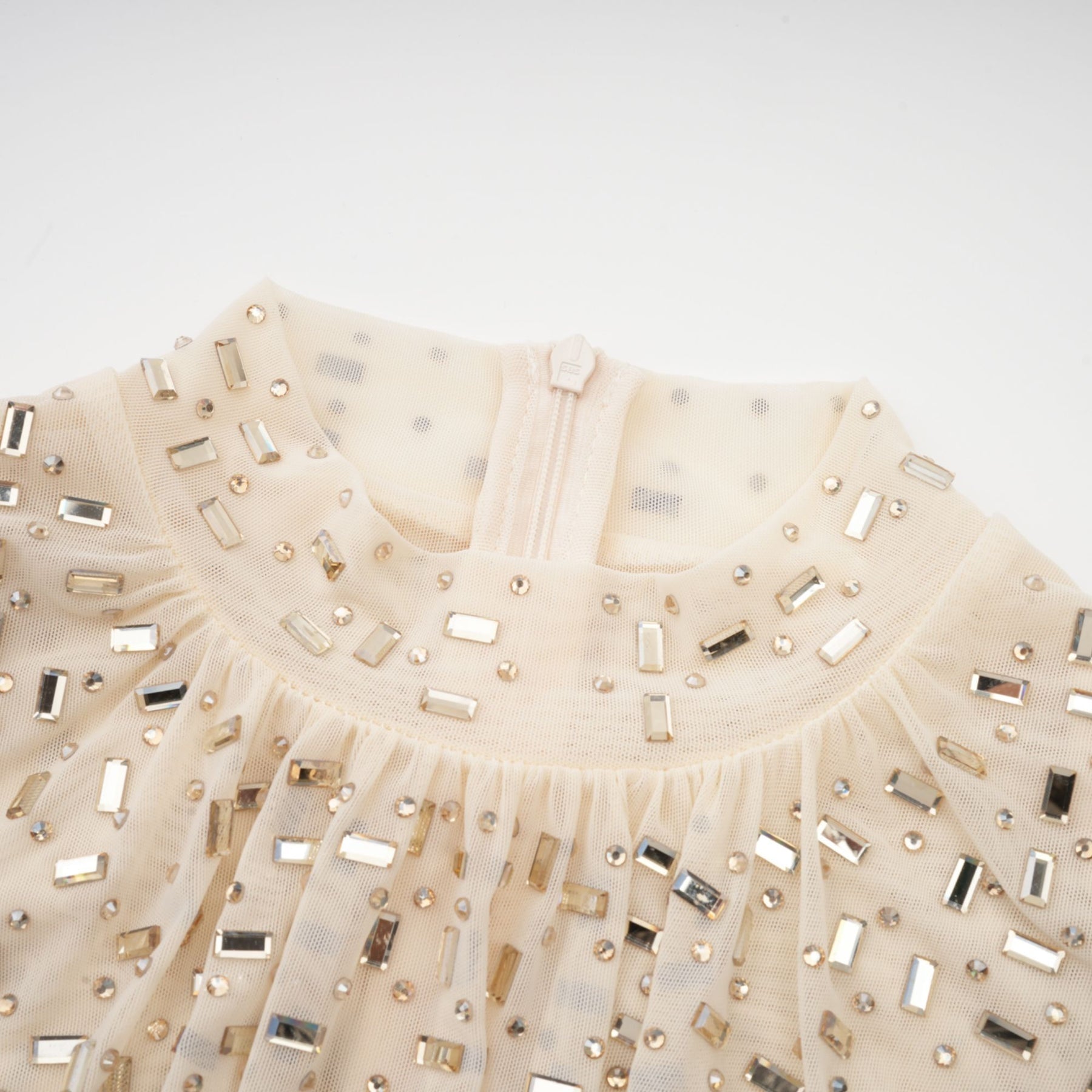 A short draped mini dress with crystal embellishments designed by Noémie