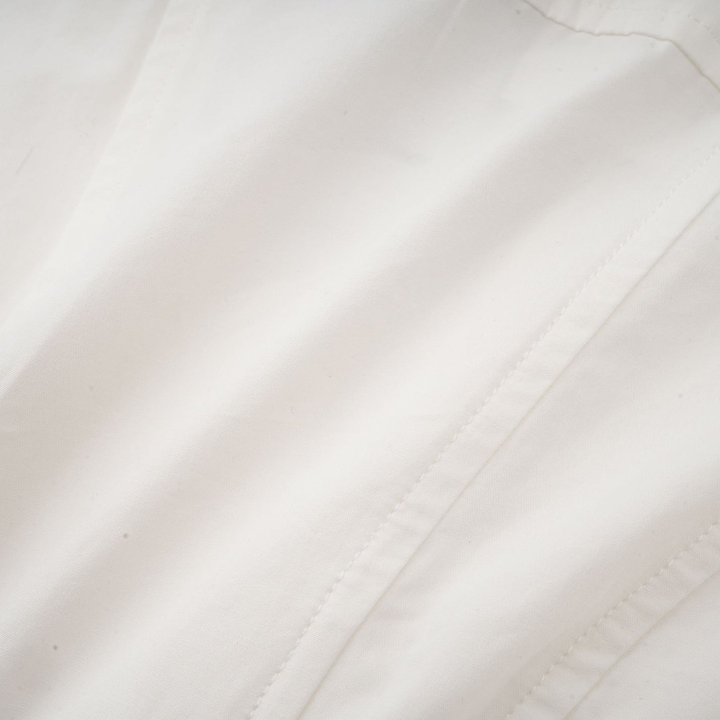 Alt text White pleated mini shirt dress with fitted waist by Orlane