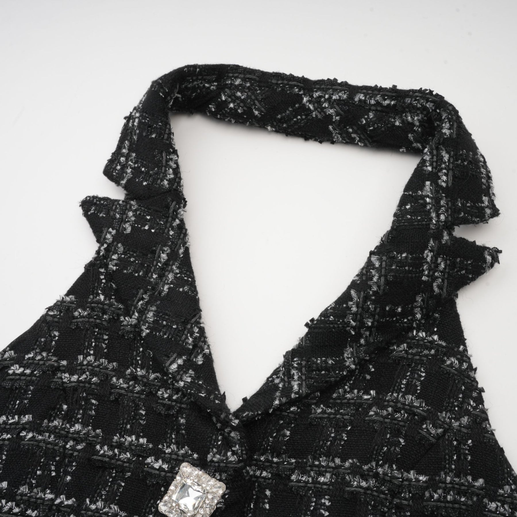Woman wearing black and white checked tweed vest top and matching skirt set called Axelle