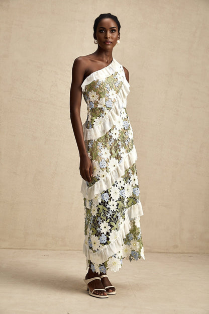 A floral embroidered midi dress in a light color with a feminine silhouette and delicate flower pattern