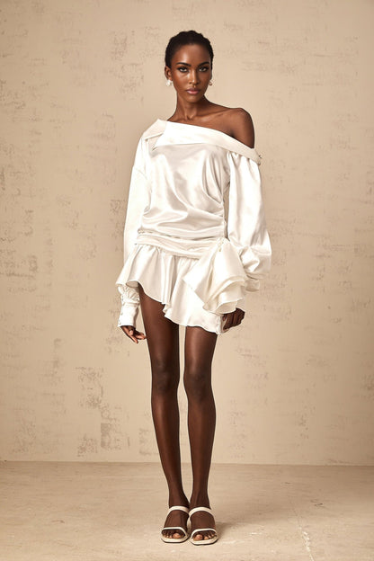 A white satin mini dress with a deconstructed design featuring asymmetrical panels and draping named Xenia