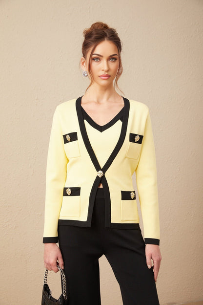 Woman wearing matching knit cardigan vest and trousers set with contrasting trim in Eloise style