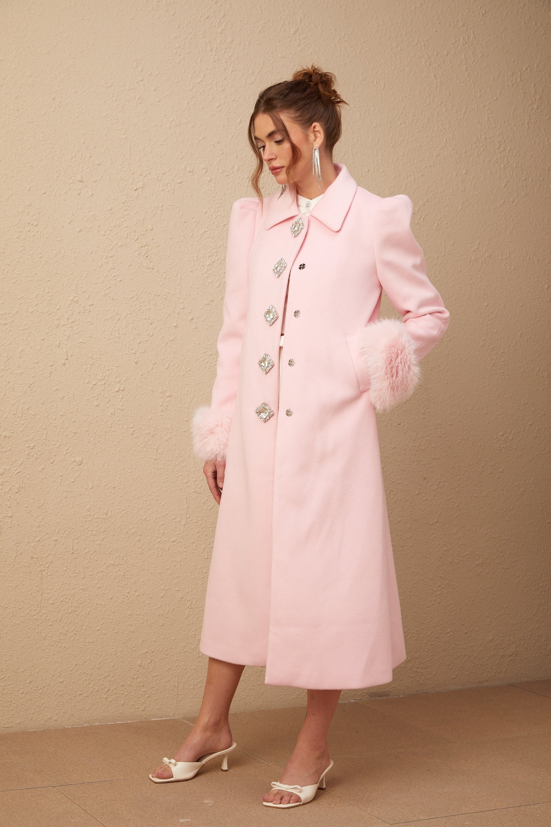 A pink fluffy overcoat with a luxurious faux fur texture named Louisette