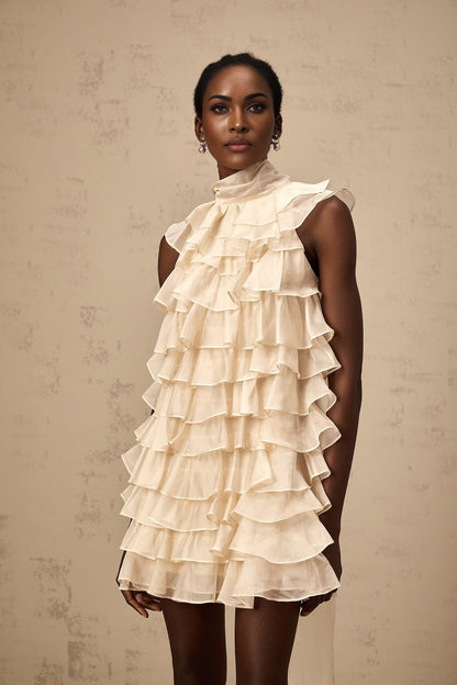 Woman wearing sleeveless mini dress with tiered flounce detail