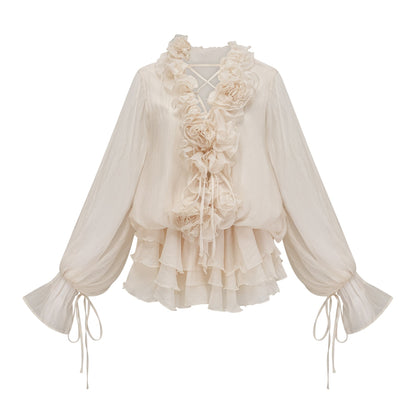 A short neutral colored tiered mini dress with floral applique details named Zephyrine