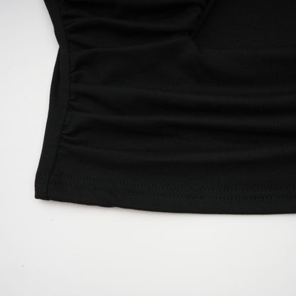 A black sleeveless top with an open front design and gathered fabric detailing
