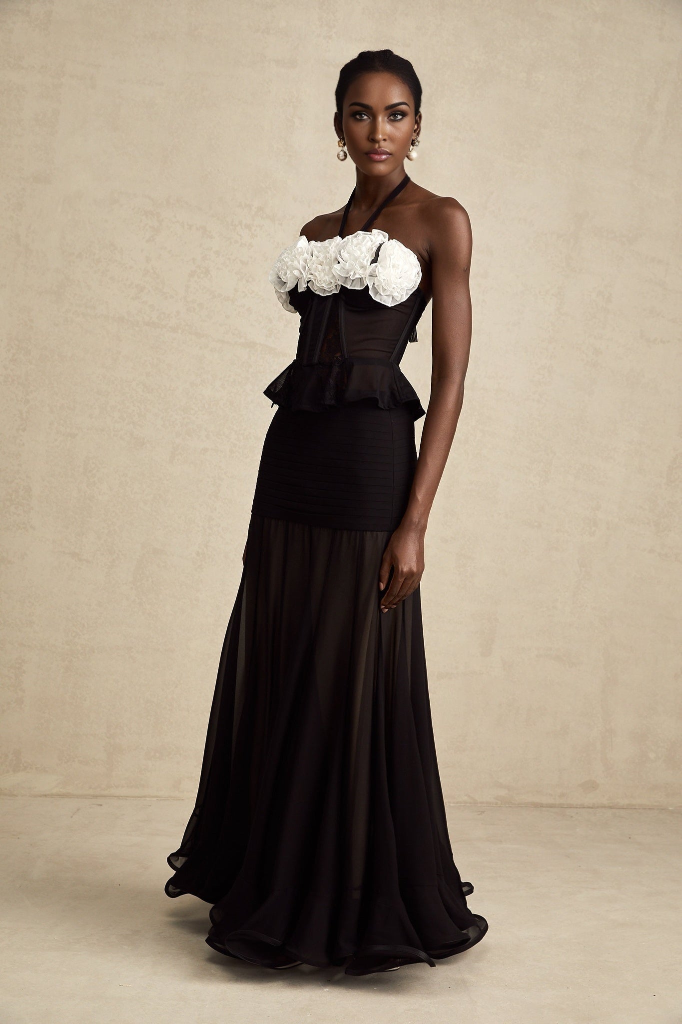 A black lace corset top with intricate floral patterns featuring sheer panels and a structured bodice