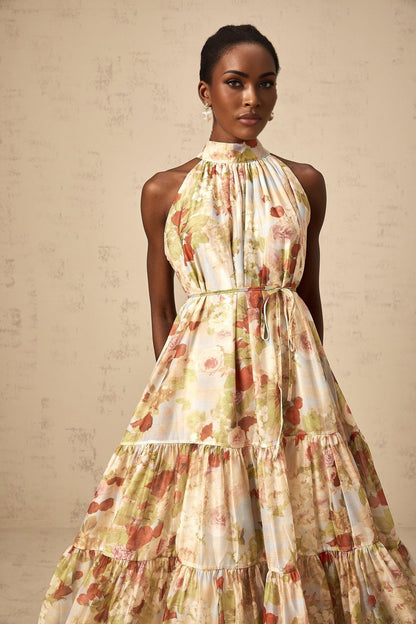 A sleeveless midi dress with a floral print in neutral colors
